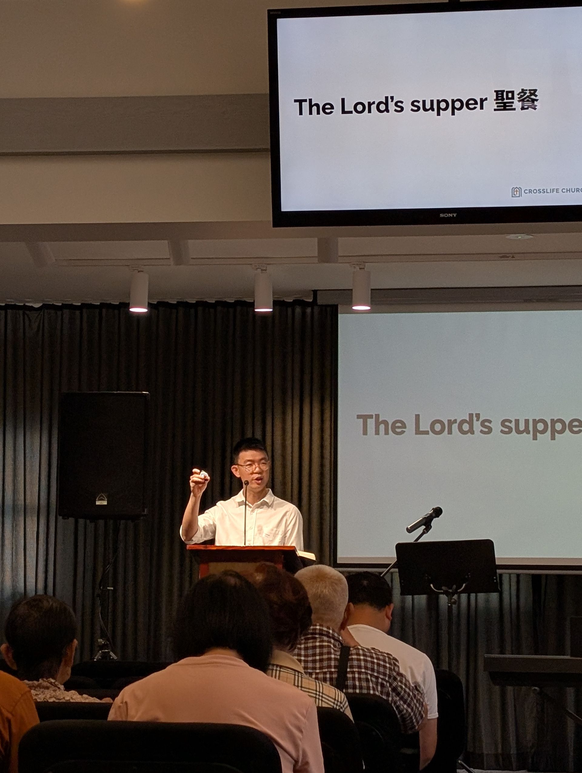 Pastor preaching on the Lord's Supper at CrossLife Church